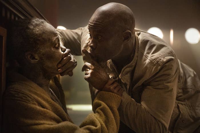 Lupita Nyong'o, Djimon Hounsou looking tense while trying to stay quiet in a scene from &quot;A Quiet Place: Day One&quot;