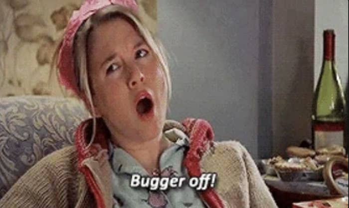 Renee Zellweger, wearing a casual outfit and a pink headband, is lounging and shouting &quot;Bugger off!&quot; in a scene from the movie Bridget Jones's Diary