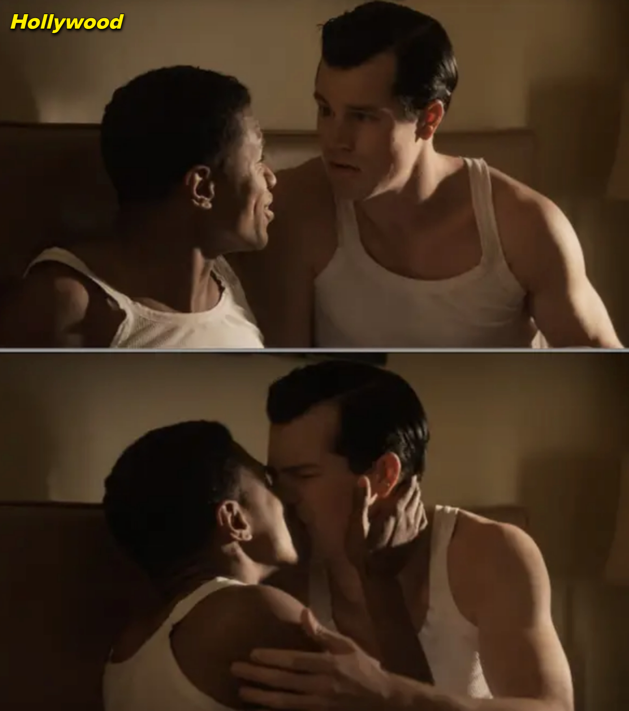 Two men sit on a bed, talking. In the next scene, they share a passionate kiss