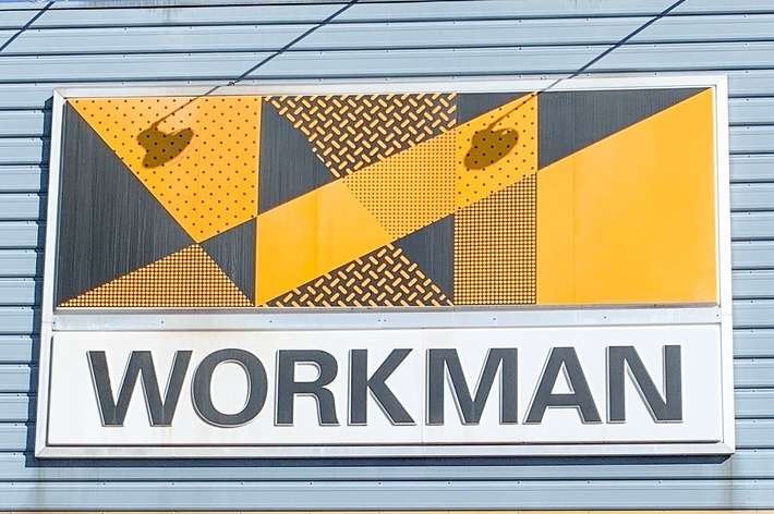 Storefront sign with the word &ldquo;WORKMAN&rdquo; below a geometric yellow and black design