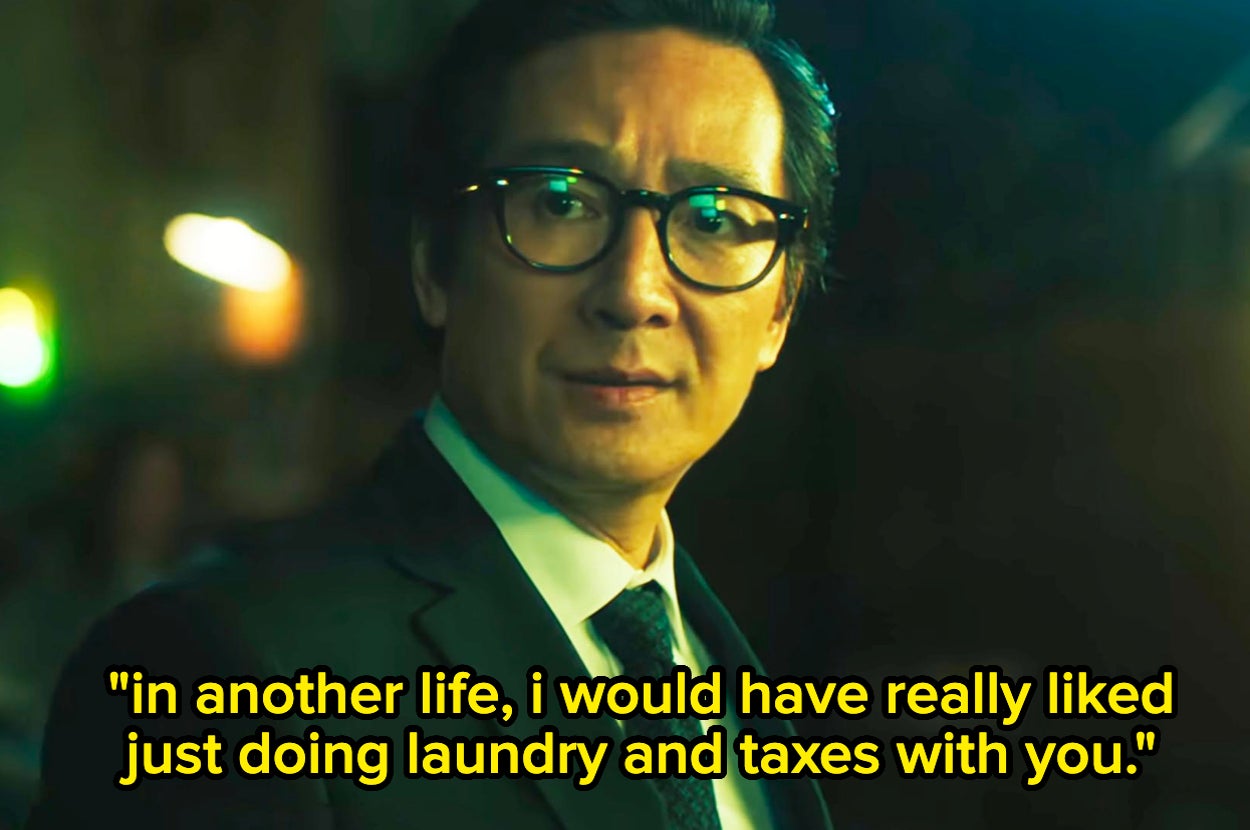Ke Huy Quan in a suit and tie, wearing glasses, with the quote: "In another life, I would have really liked just doing laundry and taxes with you."