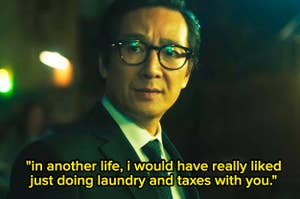 Ke Huy Quan in a suit and tie, wearing glasses, with the quote: "In another life, I would have really liked just doing laundry and taxes with you."