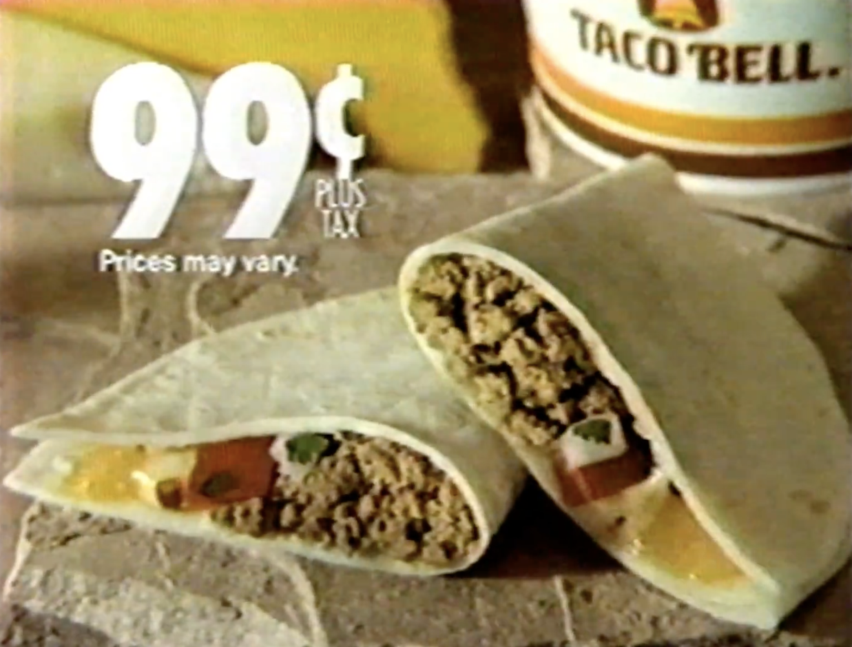 Two Taco Bell soft tacos with beef, cheese, and vegetables beside a Taco Bell drink are advertised for 99 cents plus tax. Prices may vary