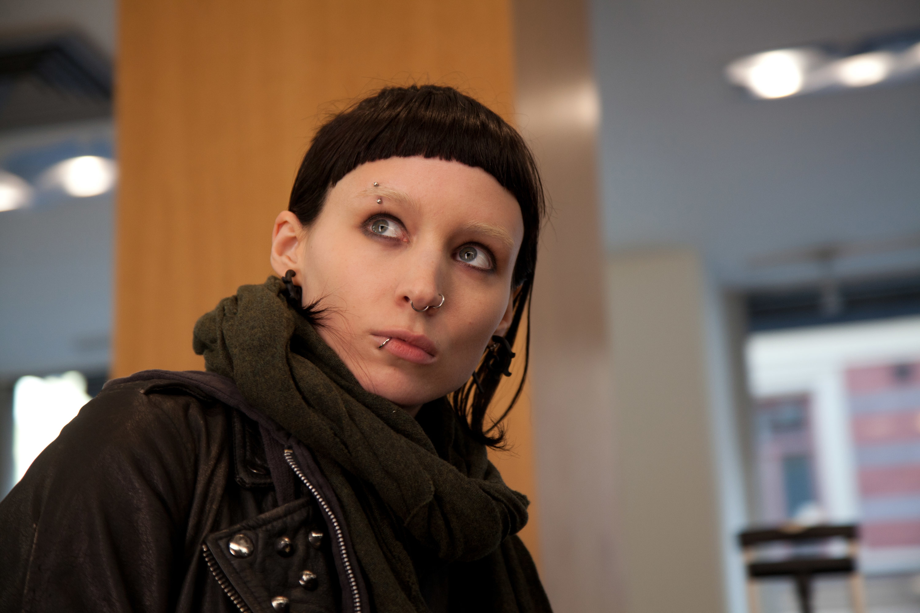 Rooney Mara, as Lisbeth Salander from the film &quot;The Girl with the Dragon Tattoo,&quot; with short black hair, piercings, and a dark scarf