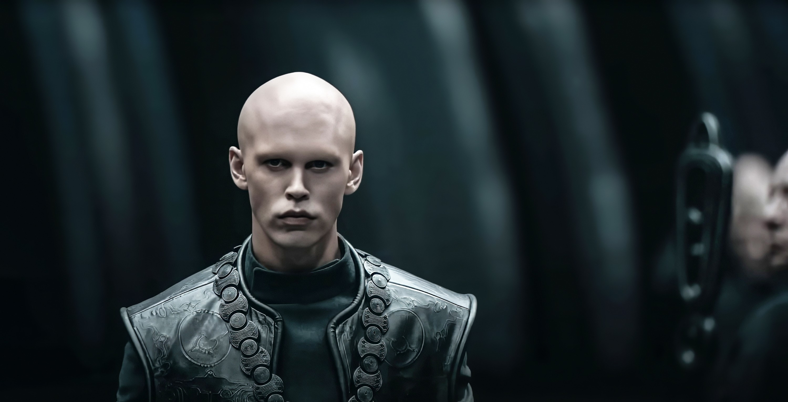 Austin Butler's character in Dune: Part Two, dressed in futuristic, intricately detailed armor, appears serious and intense