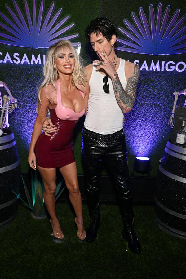 Megan Fox in a fitted dress and Machine Gun Kelly in a tank top and leather pants at a Casamigos event. Emma is seen holding a cigarette