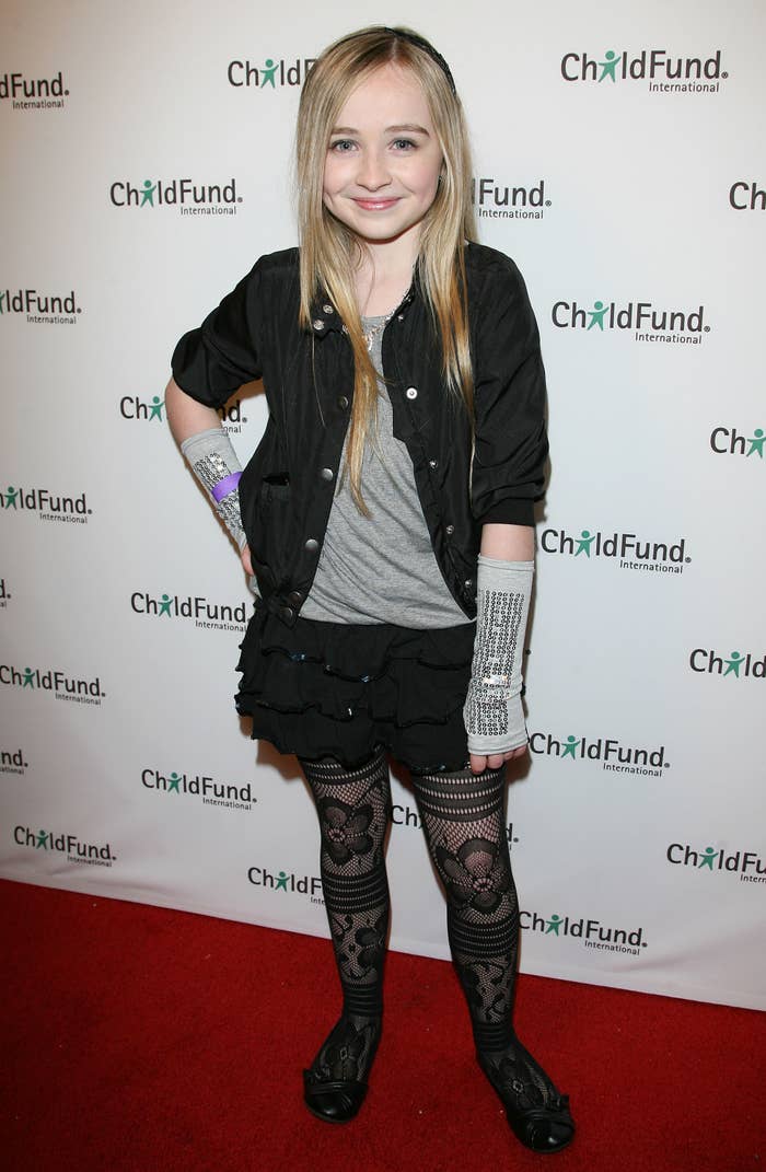 Sabrina Carpenter poses on the red carpet at a ChildFund International event, wearing a casual chic outfit with patterned tights and fingerless gloves
