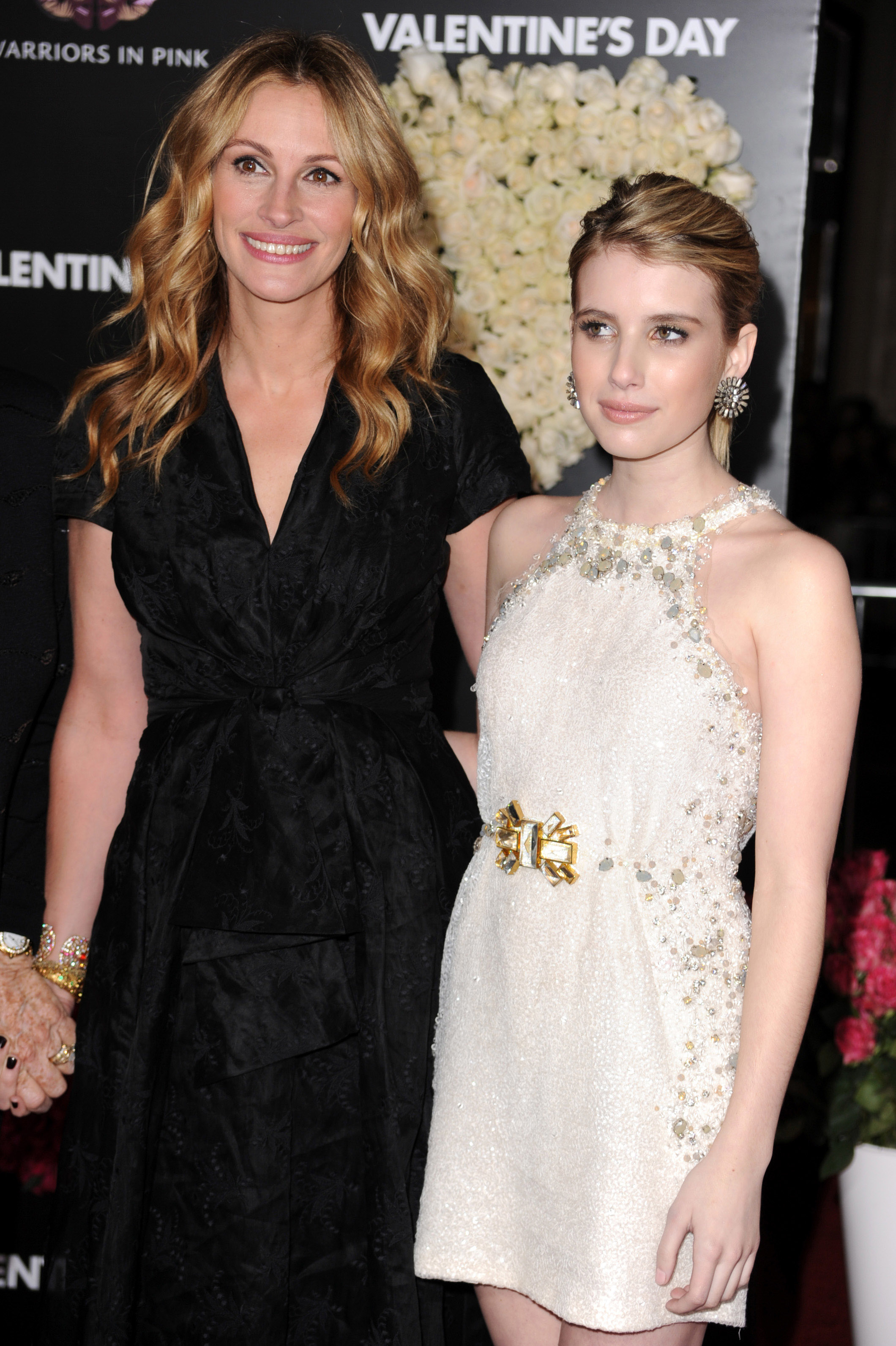 Julia Roberts in a black dress and Emma Roberts in a white dress at a "Valentine's Day" event