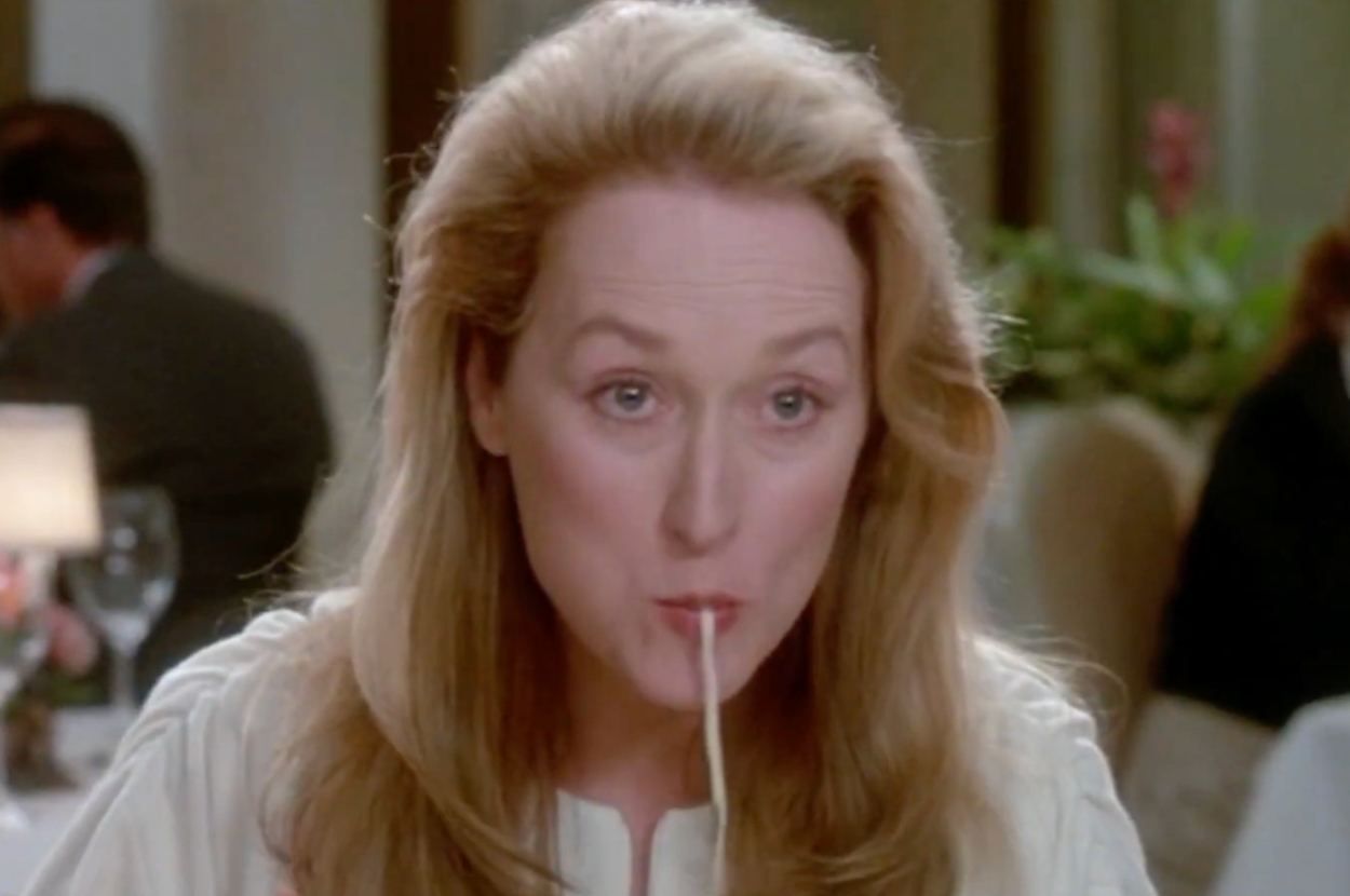 Meryl Streep eating spaghetti at a restaurant