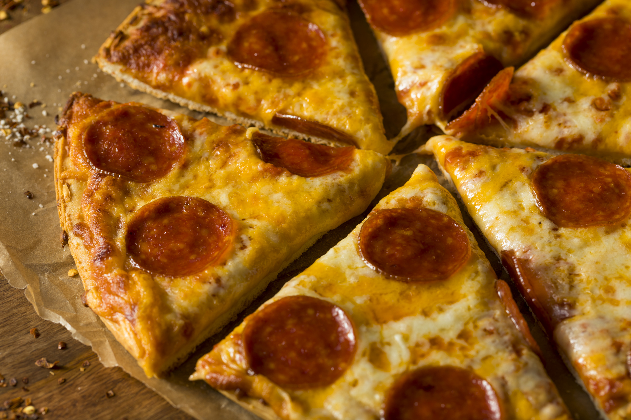 Slices of pepperoni pizza on parchment paper