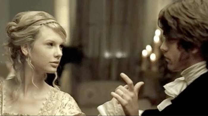 Taylor Swift and Justin Gaston in a scene from the &quot;Love Story&quot; music video, dressed in period costume reminiscent of a Renaissance ball