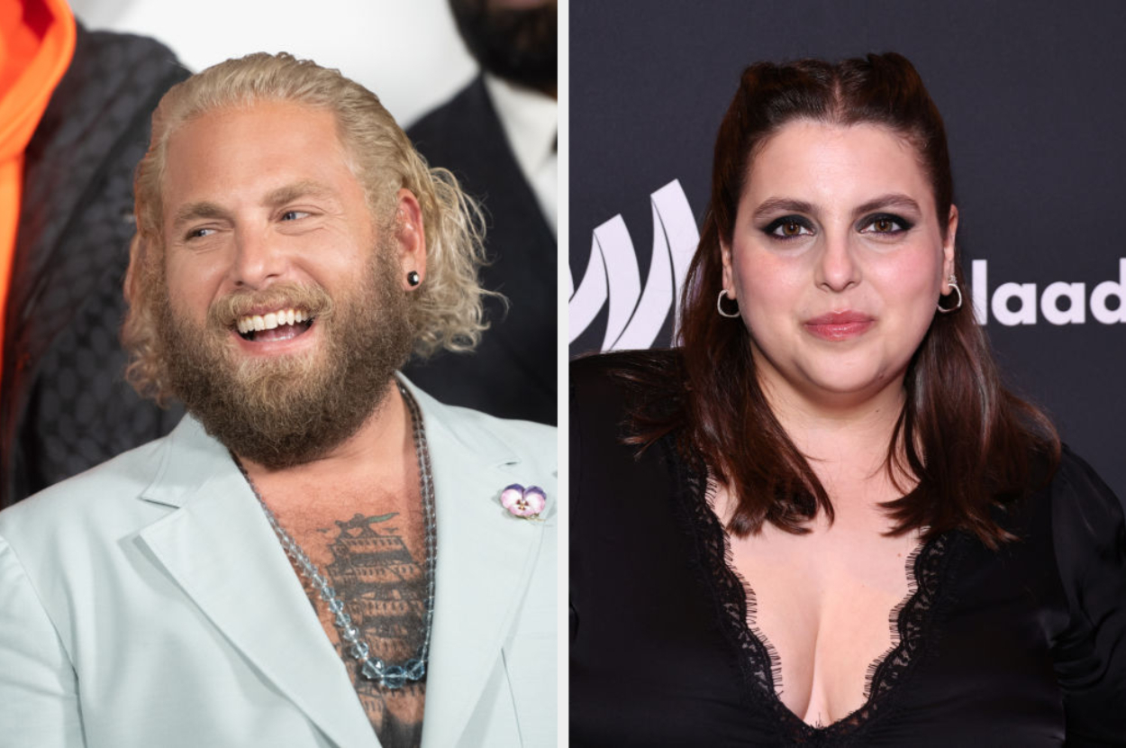 Jonah Hill, with a beard and tattoos, in a light suit on the left. Beanie Feldstein, in a black outfit with a lace neckline, on the right at a GLAAD event