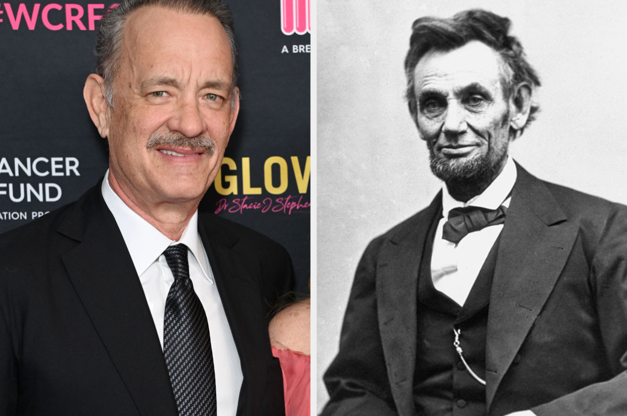 Tom Hanks at an event standing beside an old black-and-white photograph of Abraham Lincoln