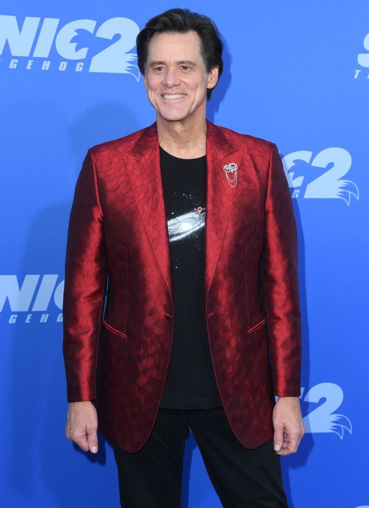 Jim Carrey on the red carpet at the "Sonic the Hedgehog 2" premiere, wearing a patterned blazer over a T-shirt