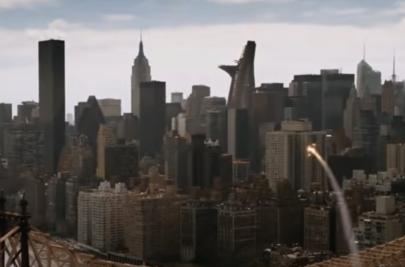 A city skyline with a rocket or missile flying towards a skyscraper. The distinctive Avengers Tower is visible among the buildings