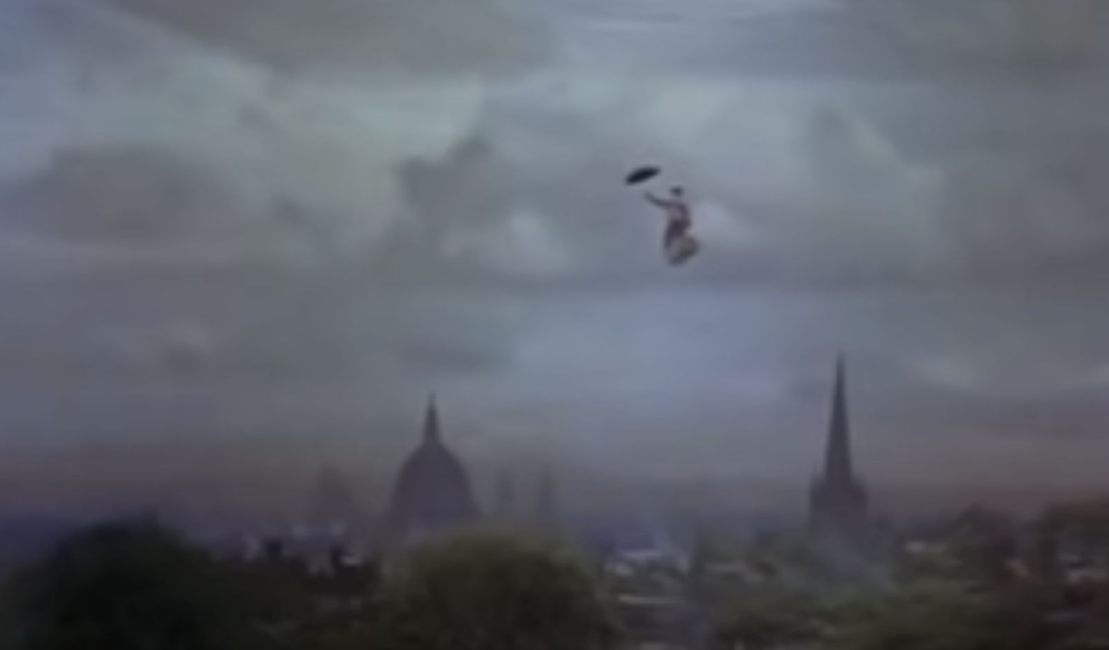 Mary Poppins hovers over a cityscape, clutching her umbrella, with the tops of buildings visible below