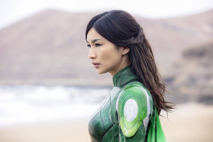 Gemma Chan, in futuristic armor-style attire, gazes intently in a scene from &quot;Eternals&quot;