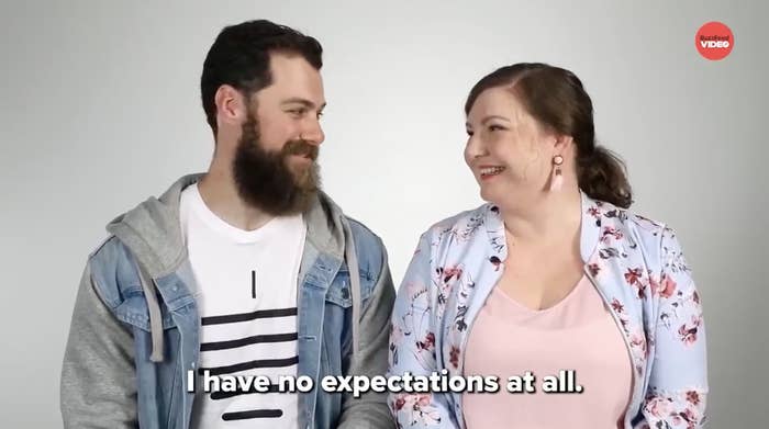 Man and woman smiling at each other, subtitle reads, I have no expectations at all