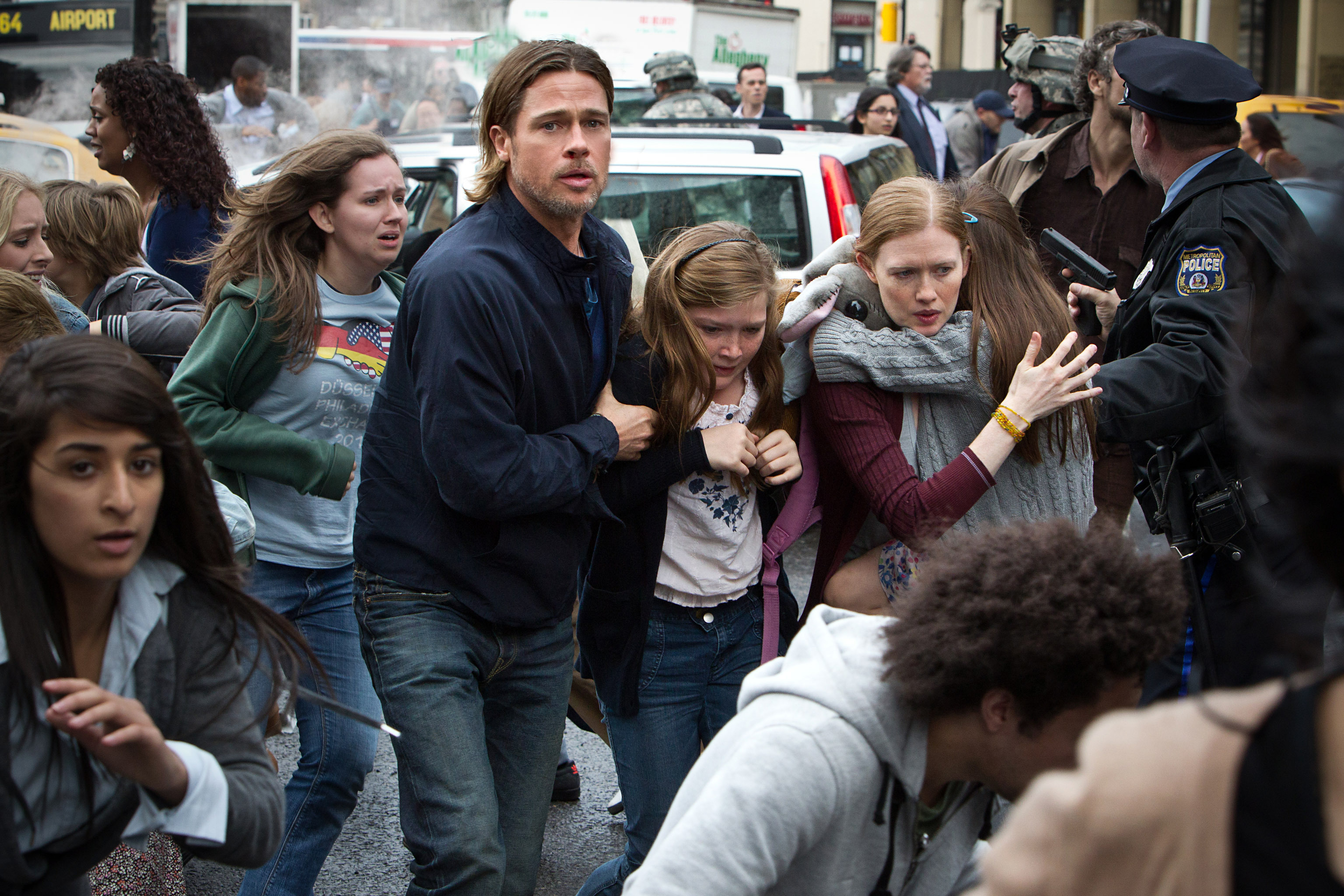 Brad Pitt, Abigail Hargrove, and Mireille Enos fleeing with a group of people in a scene from &quot;World War Z&quot;