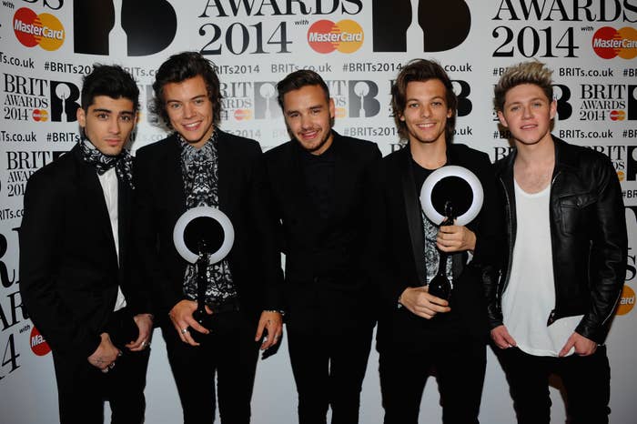 Zayn Malik, Harry Styles, Liam Payne, Louis Tomlinson, and Niall Horan smile while holding awards at the Brit Awards 2014