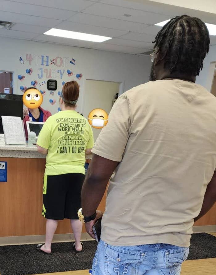 People at a counter; one person in a yellow shirt with "You can either expect me to work well or pass a drug test" on the back, another in a beige shirt. "4th of July" decoration