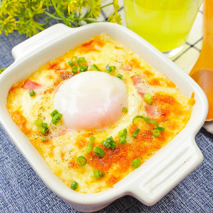 グラタンと黄色い飲み物が並ぶ食卓の風景。