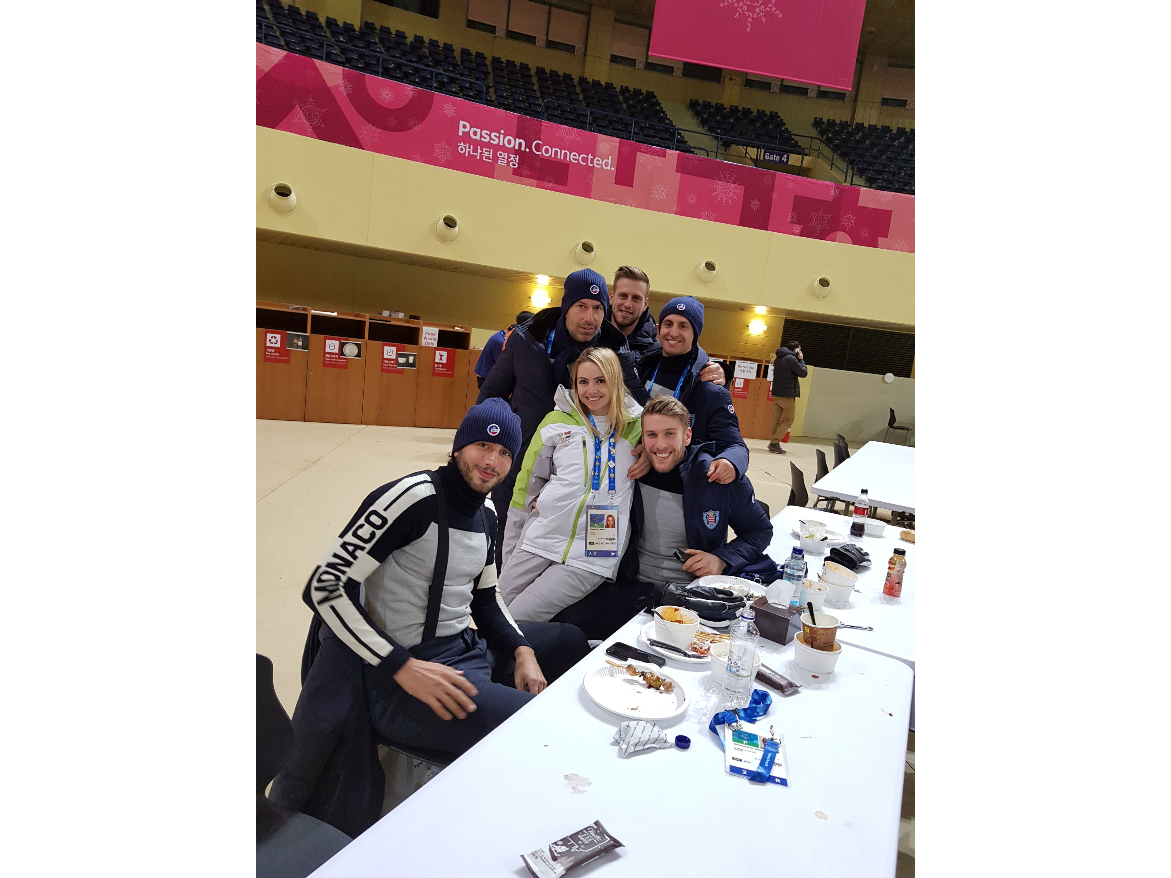 Elizabeth Swaney with the Monaco bobsled team in the Olympic Village dining hall of the 2018 Winter Olympics in PyeongChang