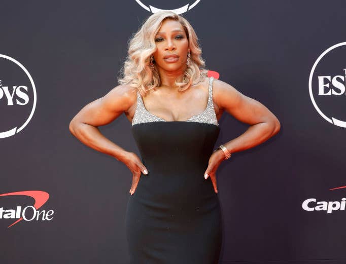 Serena Williams poses on the red carpet at the ESPY Awards in a sleek, floor-length black gown with metallic accents
