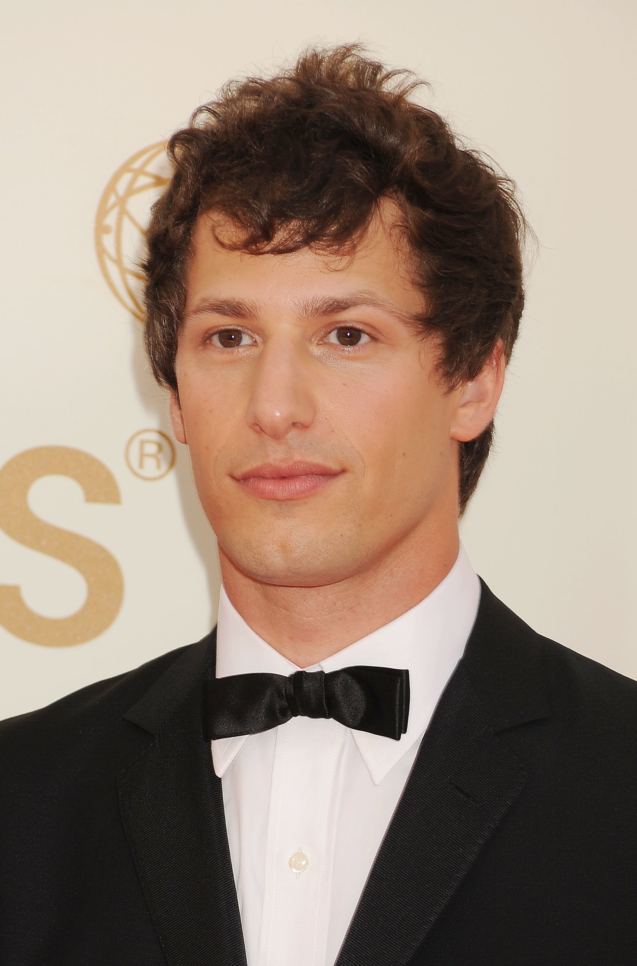 Andy Samberg in a tuxedo with a bow tie at a celebrity event