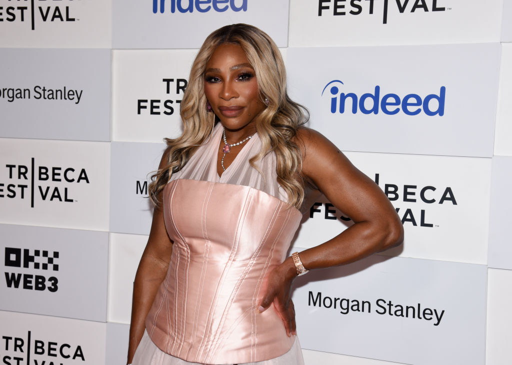 Serena Williams poses on the red carpet at the Tribeca Festival, wearing a strapless, corset-style top and flowy skirt