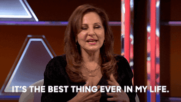 Kathy Najimy gestures while speaking on a talk show set, with the caption "It's the best thing ever in my life"