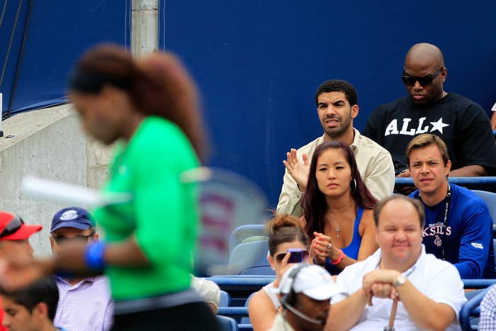 Serena Williams playing tennis with Drake and others watching from the stands