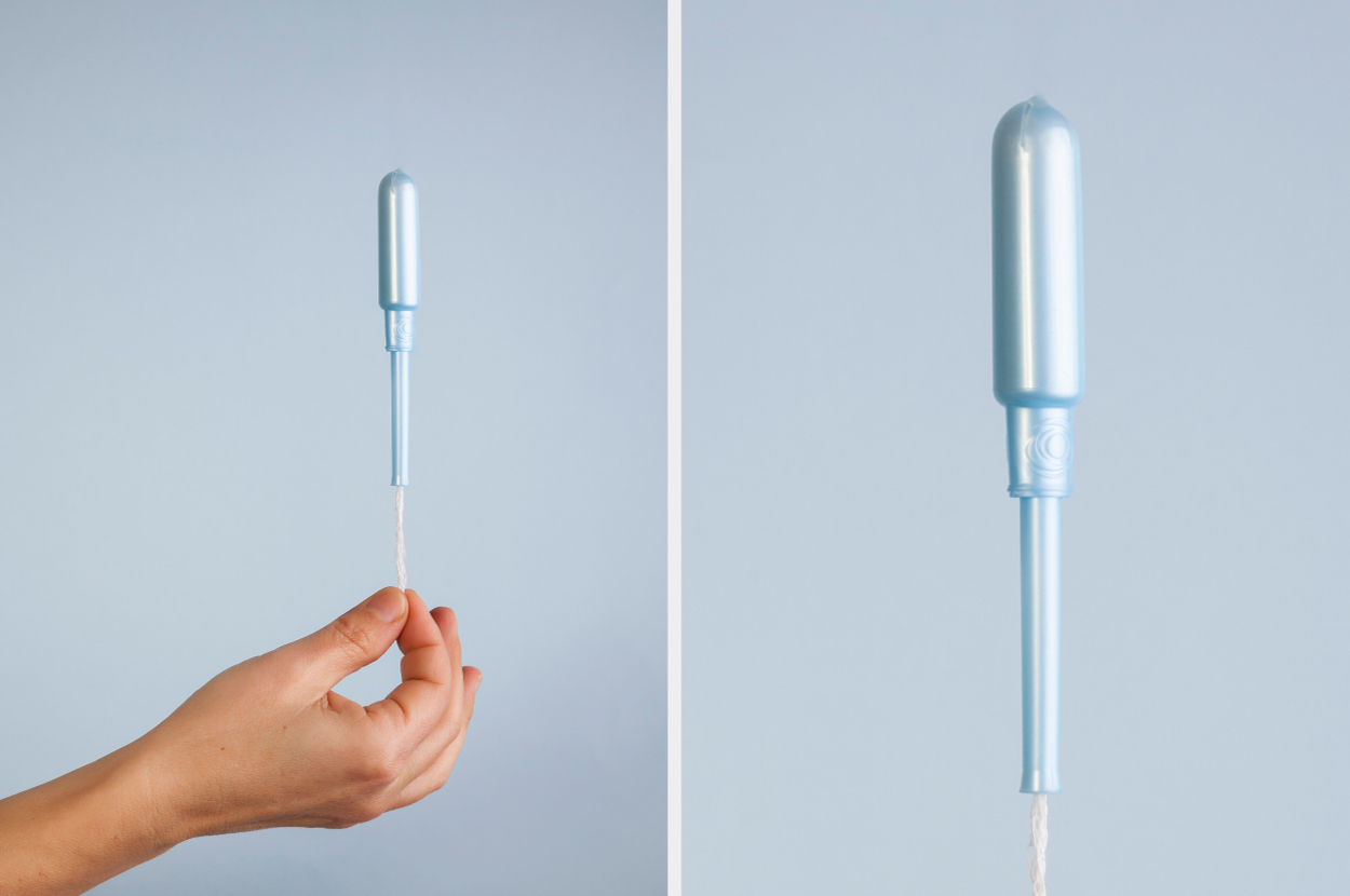 A hand holding a tampon applicator, demonstrating its design and usage