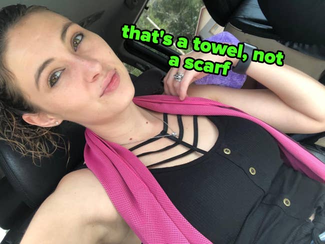 Reviewer successful  a car   wearing a pinkish  cooling towel.
