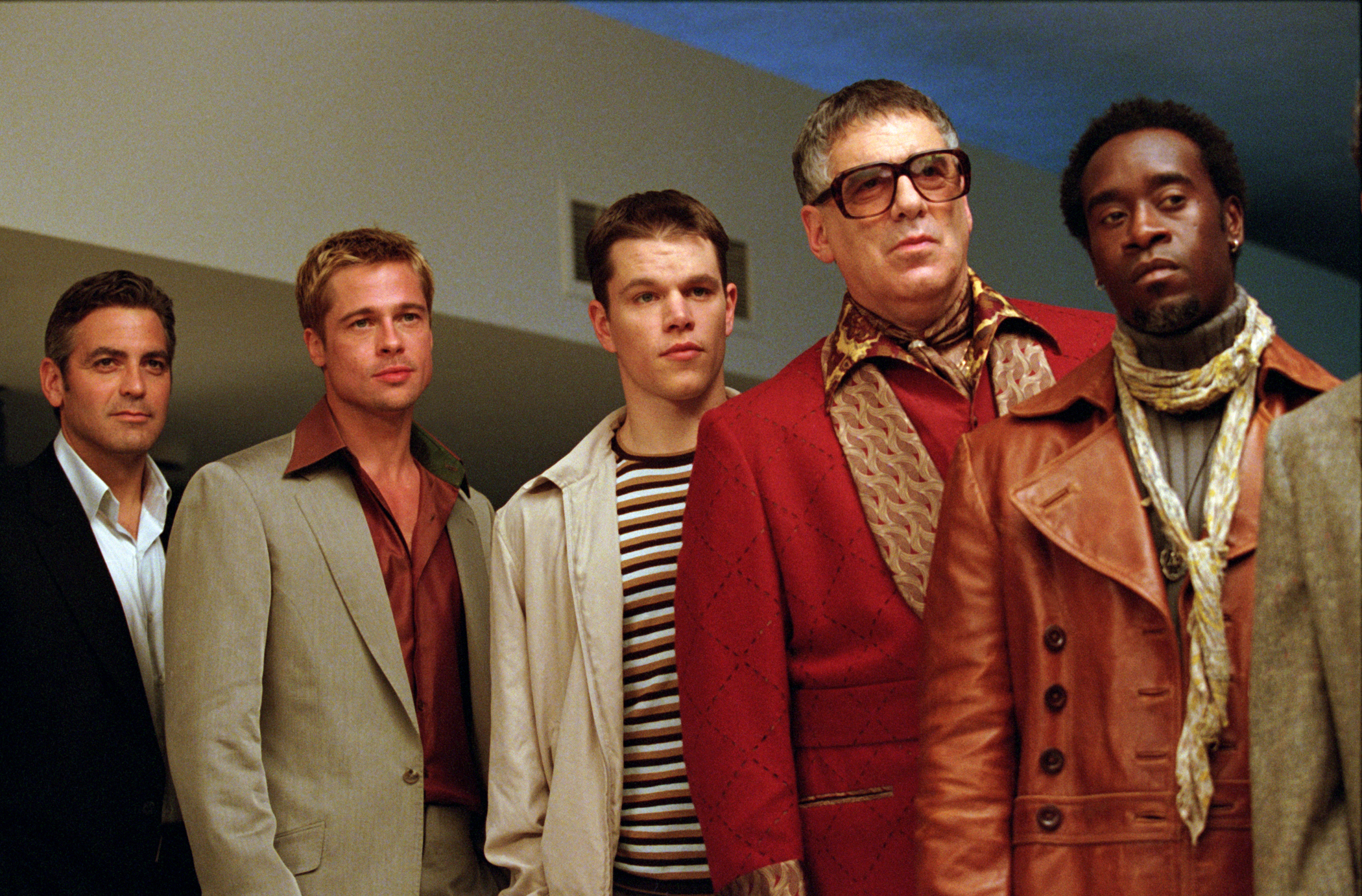 George Clooney, Brad Pitt, Matt Damon, Elliott Gould, and Don Cheadle in semi-formal outfits in a scene from &quot;Ocean's Eleven&quot;