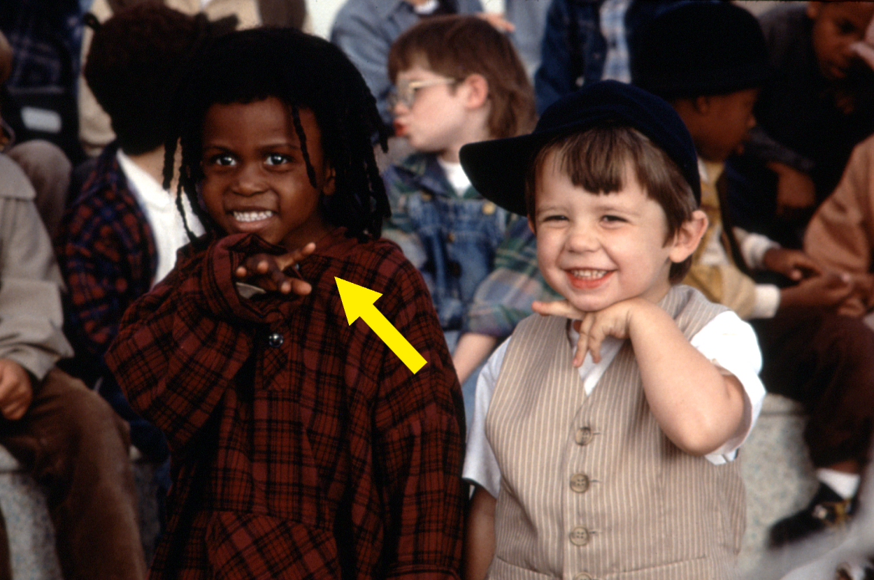 Bug Hall and Travis Tedford as Alfalfa and Spanky from "The Little Rascals" movie, smiling and posing with their hands under their chins