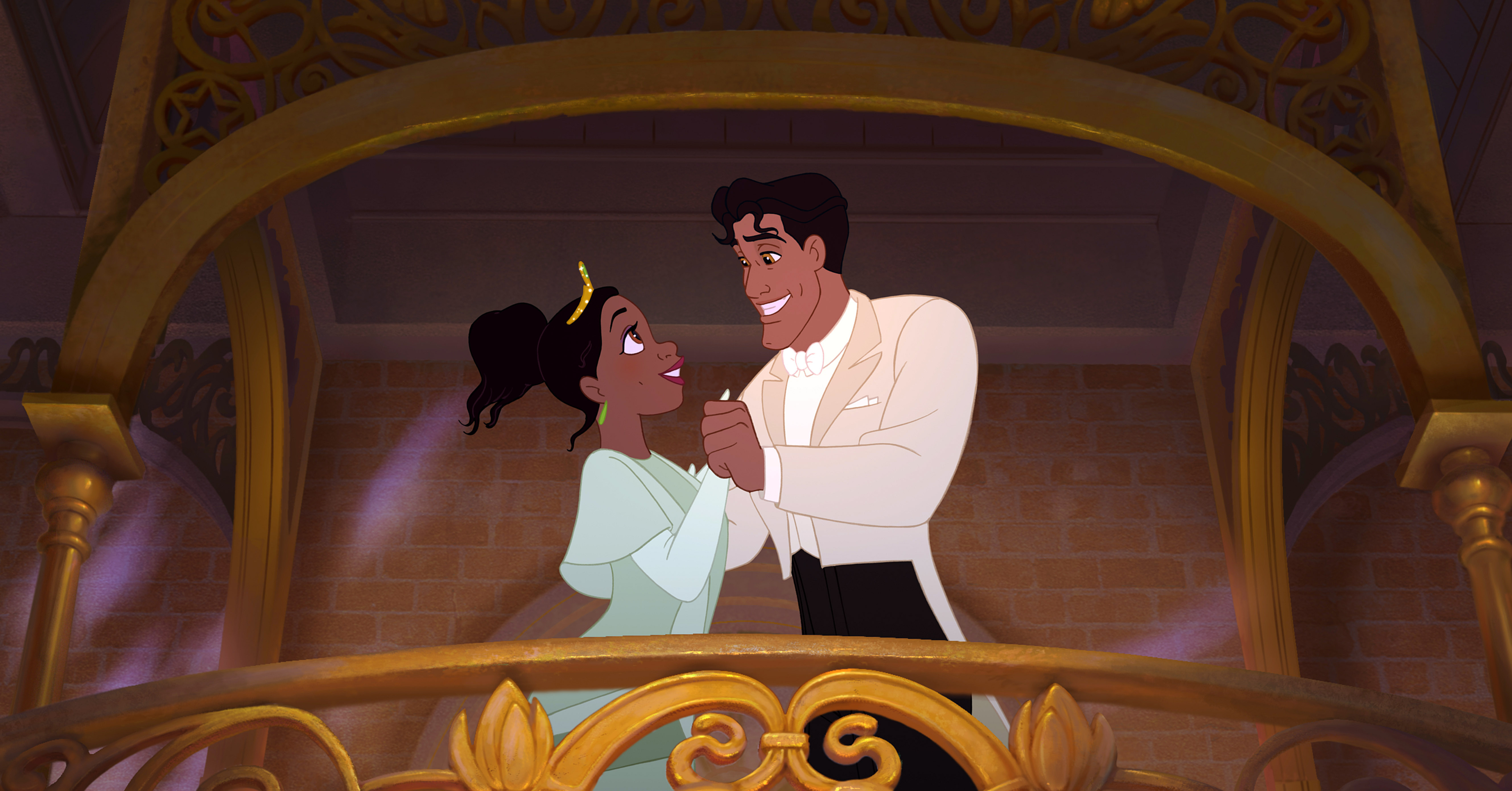 Tiana and Prince Naveen hold hands and smile at each other on a balcony in "The Princess and the Frog"