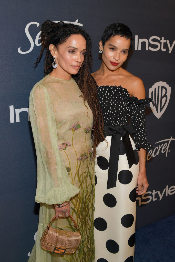 Lisa Bonet in a sheer long-sleeve dress with floral details and Zoe Kravitz in a polka-dot top with a bow belt and polka-dot skirt at an InStyle event