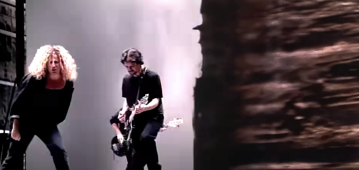 Van Halen members performing in front of a twister