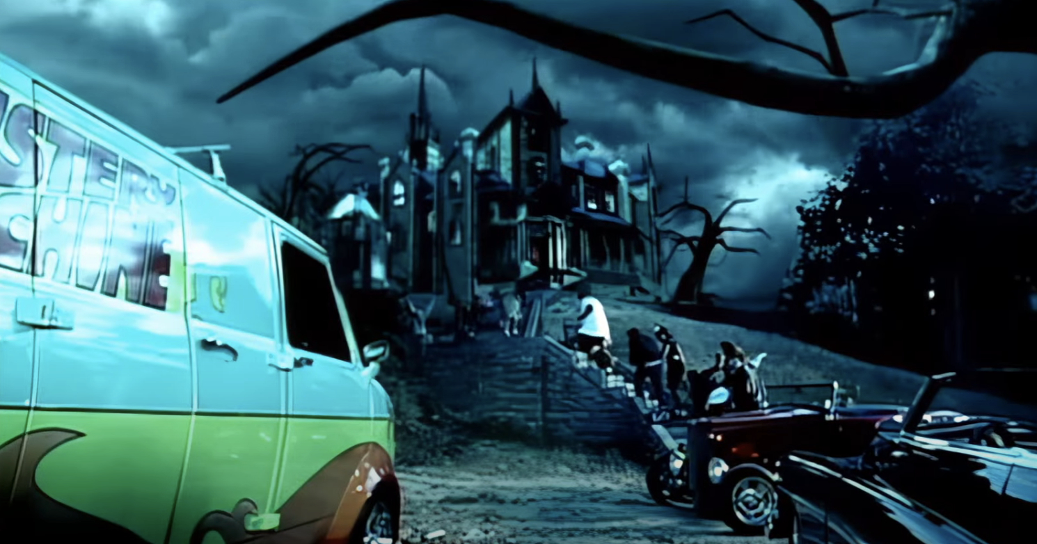 Animated scene from Scooby-Doo, with the Mystery Machine van near a spooky mansion under a dark, stormy sky