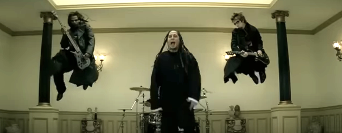 POD band members are mid-jump with guitars