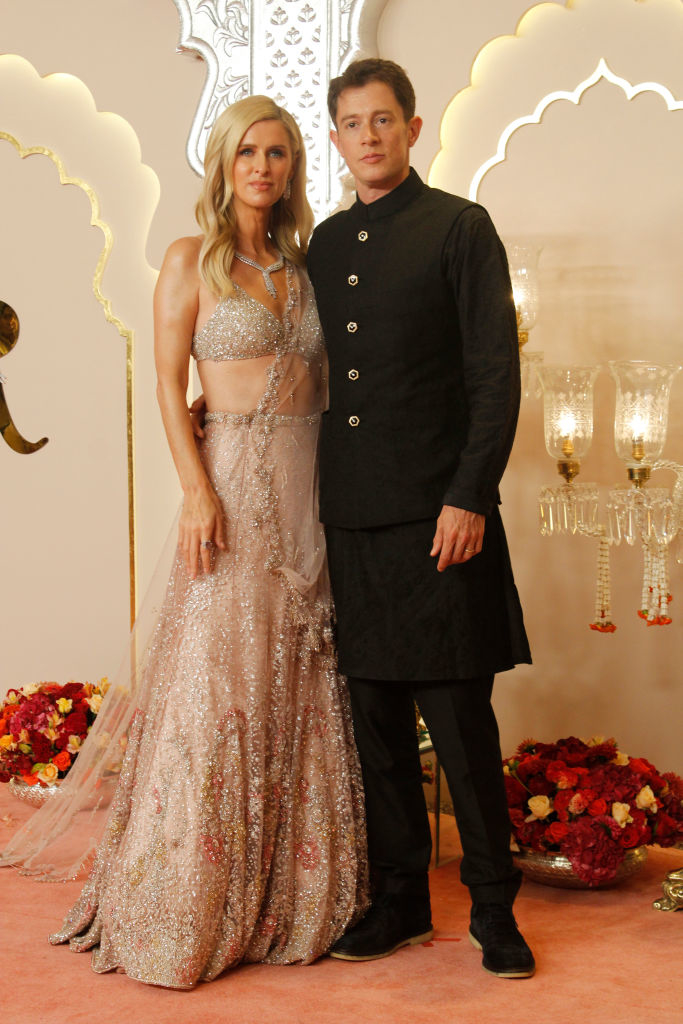 Nicky Hilton and James Rothschild standing together. Nicky wears an embellished gown with intricate details, and James wears a sherwani