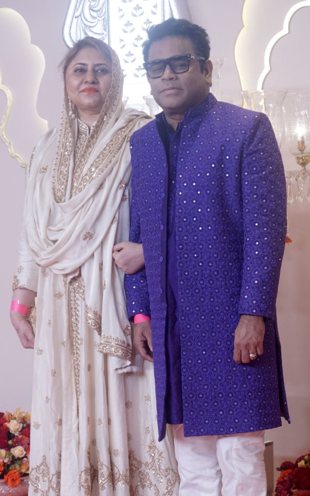 A.R. Rahman in a sherwani with intricate patterns, and Saira Banu in a traditional outfit with sparkly details, attending a formal event