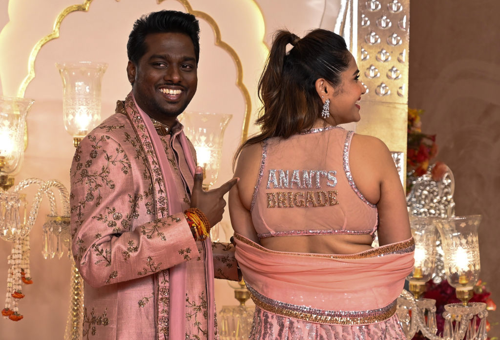 Atlee Kumar points to a Krishna Priya's top that reads "Anant's Brigade"