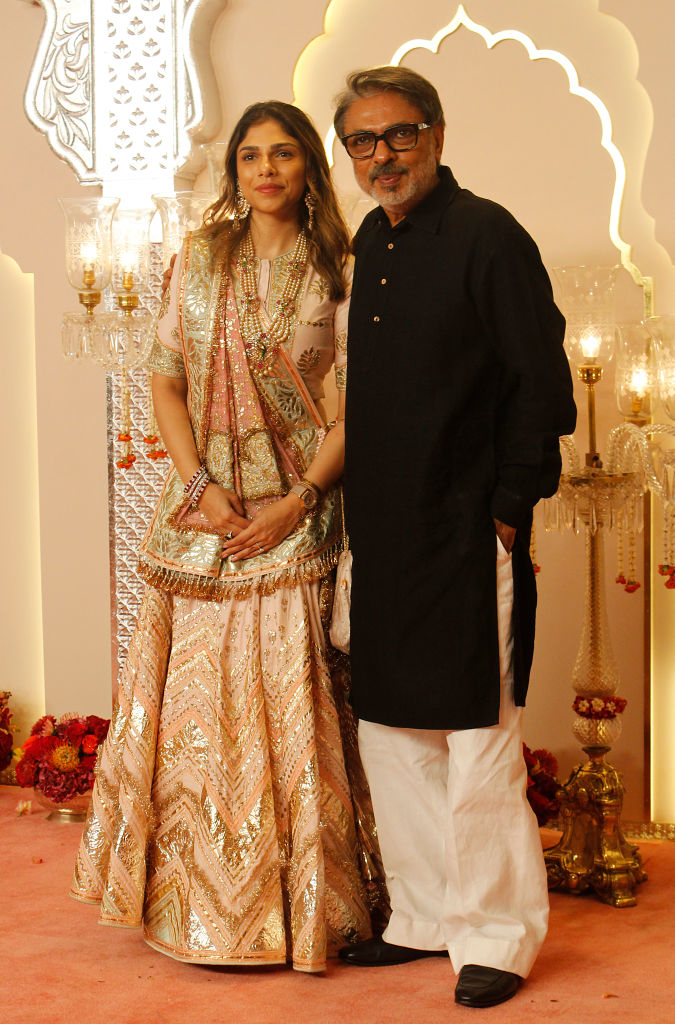 Sharmin in a lehenga and Sanjay in dark kurta and light pants, posing at a formal event