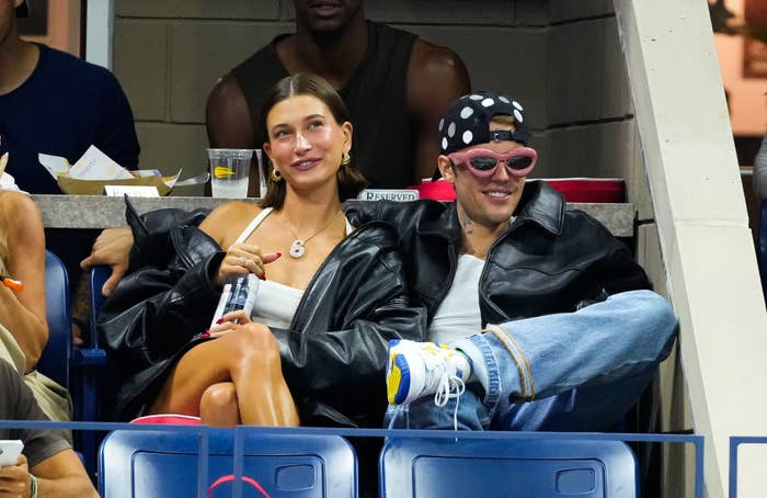 Hailey Bieber and Justin Bieber sit together in an audience