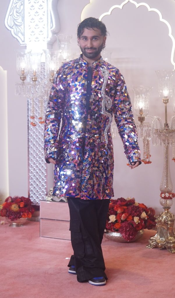 Orry Awatramani in a sequin outfit, posing on a red carpet at a formal event