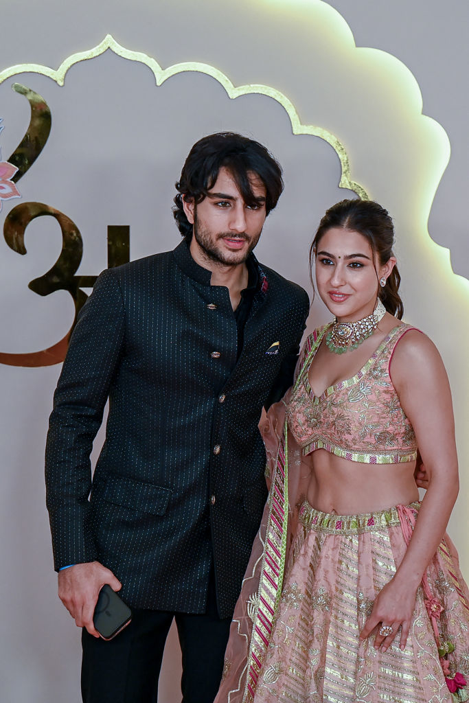 Sara Ali Khan in an embellished lehenga with a sleeveless blouse and Ibrahim Ali Khan in a stylish suit pose together at an event