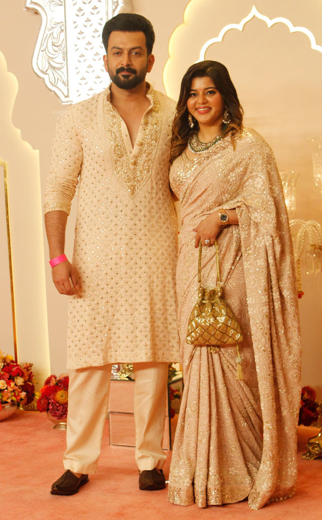 Prithviraj Sukumaran in an embroidered traditional outfit and Supriya Menon in an ornate saree at a formal event