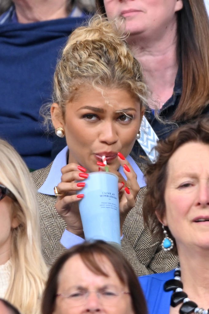 Zendaya drinks from a cup using a straw